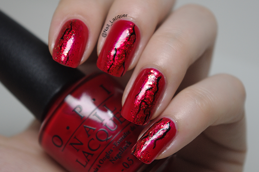 dark red sparkly nail lacquer with black design