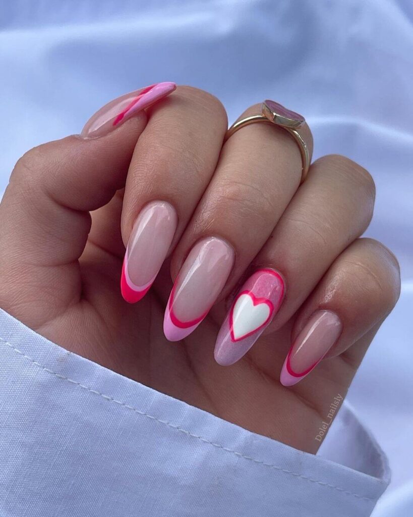 pink nails with white heart on ring finger